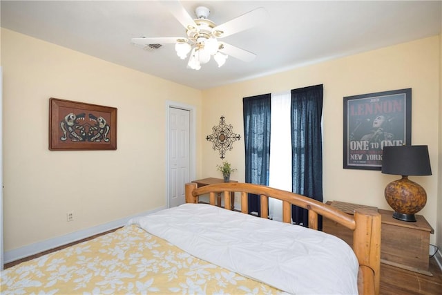 bedroom featuring ceiling fan, a closet, and hardwood / wood-style flooring