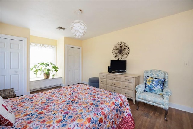 bedroom with dark wood-type flooring