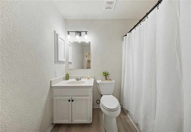 7926 Falcon Dr, Corpus Christi, TX 78414 - full bathroom with a textured wall, wood finished floors, and vanity