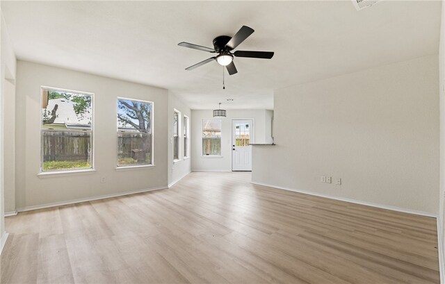7926 Falcon Dr, Corpus Christi, TX 78414 - unfurnished living room with light wood-style flooring, healthy amount of natural light, and a ceiling fan
