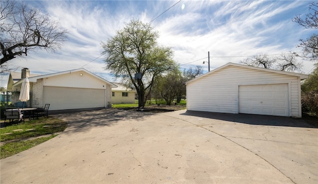 view of side of home featuring an outbuilding and a garage