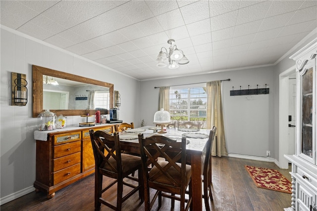 dining space with a notable chandelier, dark hardwood / wood-style floors, and crown molding