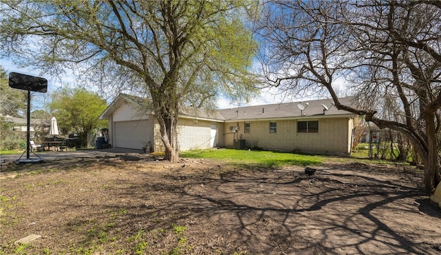 back of property with a garage