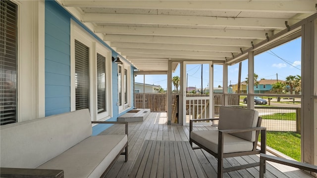 sunroom with beamed ceiling