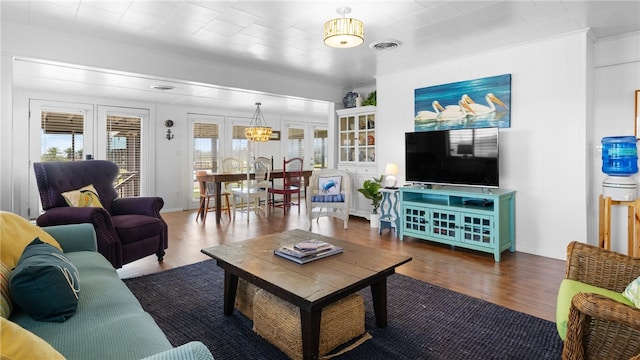 living area featuring wood finished floors and visible vents