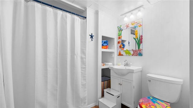 bathroom featuring toilet and vanity