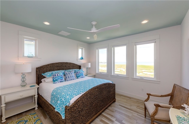 bedroom with ceiling fan and light hardwood / wood-style flooring