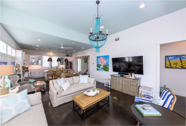 living room featuring ceiling fan with notable chandelier