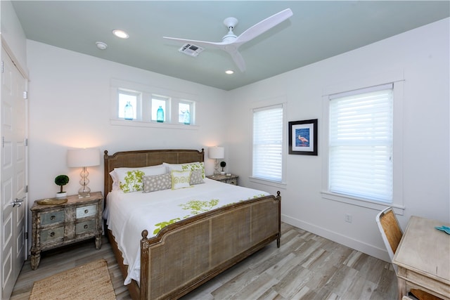 bedroom with light hardwood / wood-style floors and ceiling fan