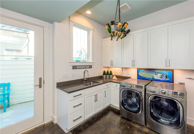 126 Reserve Ln, Rockport, TX 78382 - washroom with washing machine and dryer and cabinet space