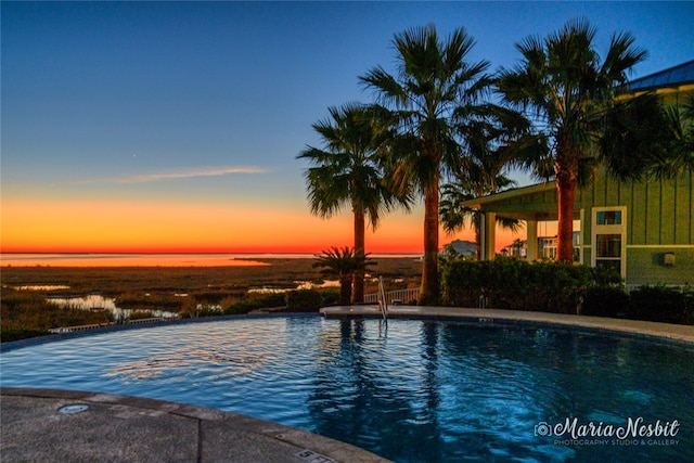 pool at dusk with a water view