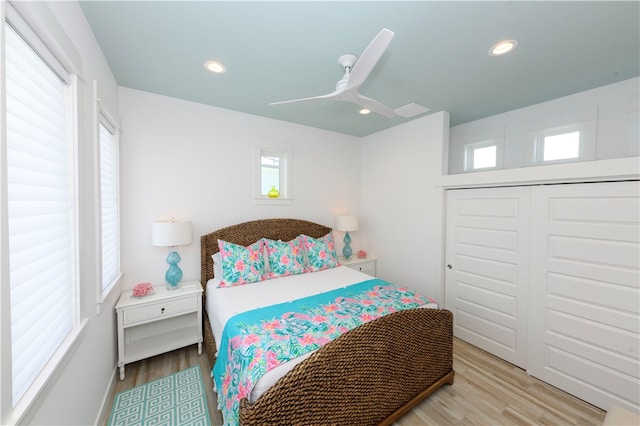 bedroom with a closet, ceiling fan, and light hardwood / wood-style floors