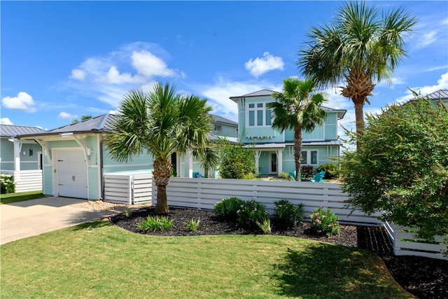 view of front of property featuring a garage and a front lawn