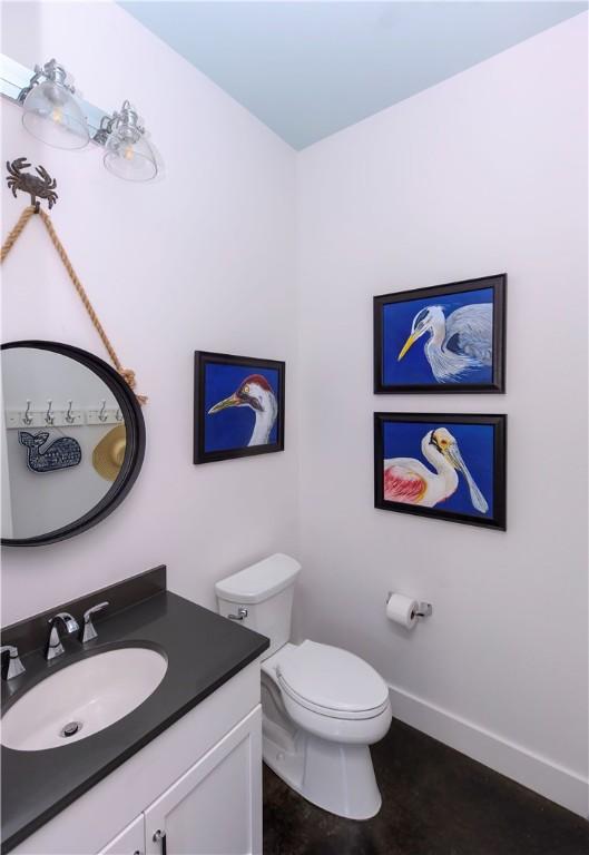 126 Reserve Ln, Rockport, TX 78382 - half bath featuring toilet, vanity, and baseboards
