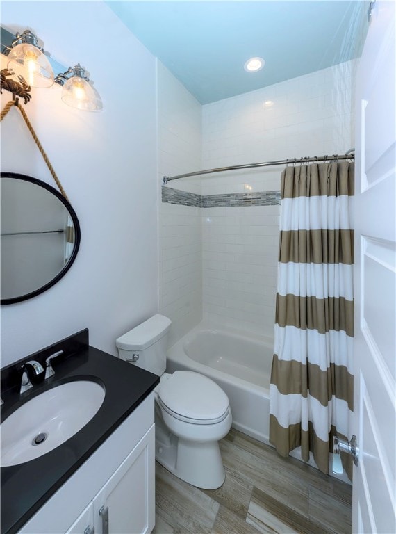 full bathroom with toilet, shower / tub combo, vanity, and wood-type flooring