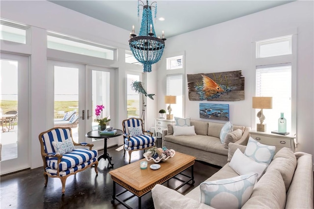 126 Reserve Ln, Rockport, TX 78382 - living room featuring french doors, a chandelier, and concrete flooring