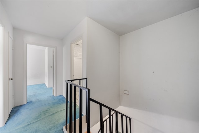 hallway with light colored carpet