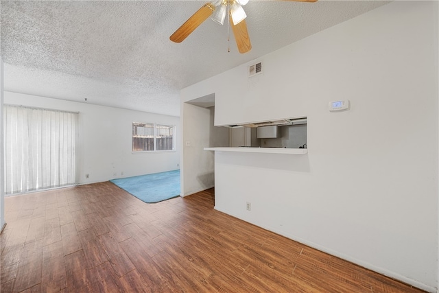 unfurnished living room featuring hardwood / wood-style floors, a textured ceiling, and ceiling fan