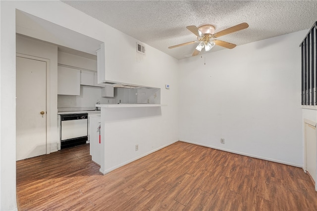 interior space featuring a textured ceiling, ceiling fan, and dark wood-type flooring