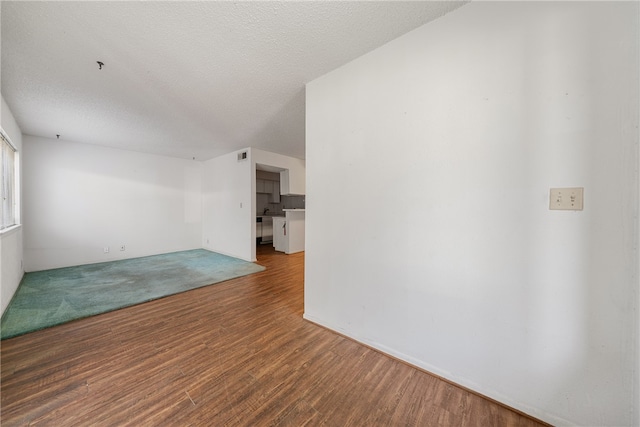 unfurnished living room with hardwood / wood-style floors and a textured ceiling