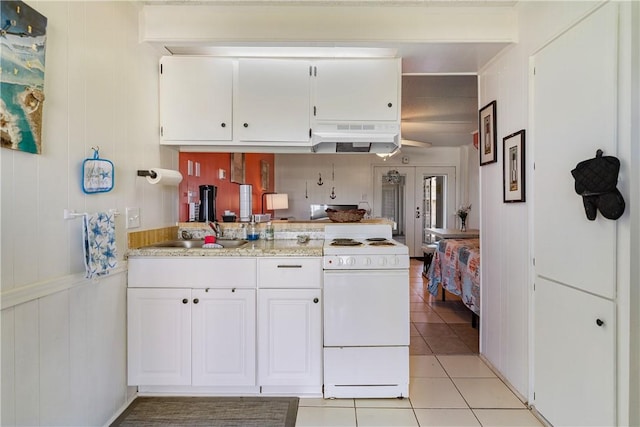 14300 S Padre Island Dr Unit 125, Corpus Christi, TX 78418 - kitchen featuring white electric range, premium range hood, light countertops, white cabinetry, and light tile patterned flooring