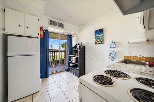 14300 S Padre Island Dr Unit 125, Corpus Christi, TX 78418 - kitchen featuring white appliances, white cabinetry, light countertops, and light tile patterned floors