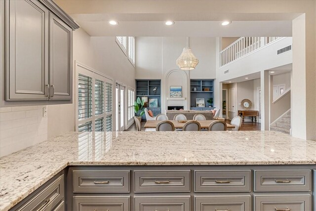 314 Bahia Mar Prt, Aransas, TX 78373 - kitchen with open floor plan, gray cabinetry, and a towering ceiling
