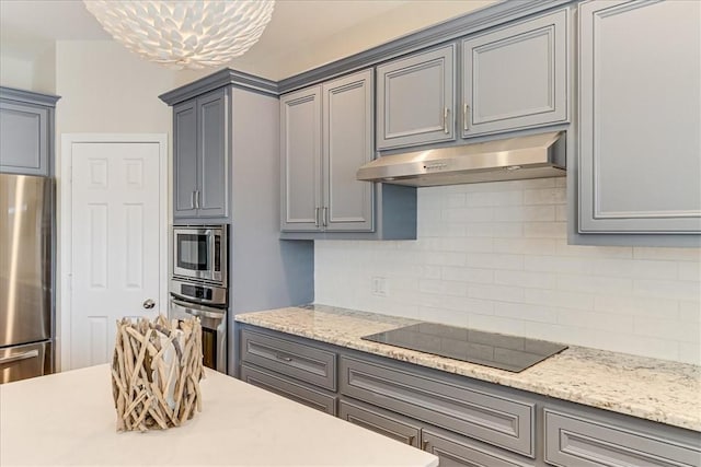 314 Bahia Mar Prt, Aransas, TX 78373 - kitchen featuring under cabinet range hood, gray cabinets, appliances with stainless steel finishes, and tasteful backsplash