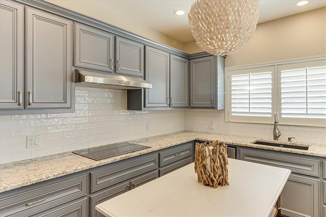 314 Bahia Mar Prt, Aransas, TX 78373 - kitchen featuring black electric cooktop, gray cabinetry, a sink, and under cabinet range hood