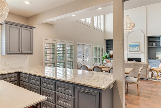 314 Bahia Mar Prt, Aransas, TX 78373 - kitchen with tasteful backsplash, gray cabinets, light wood finished floors, a peninsula, and recessed lighting
