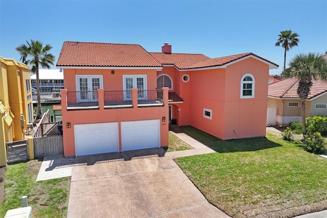 314 Bahia Mar Prt, Aransas, TX 78373 - mediterranean / spanish house with french doors, a tile roof, a chimney, and stucco siding