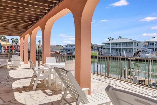 314 Bahia Mar Prt, Aransas, TX 78373 - view of patio / terrace featuring a water view, a residential view, a balcony, and outdoor dining space