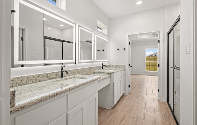 6202 Olivia St, Corpus Christi, TX 78415 - bathroom with healthy amount of natural light, a stall shower, double vanity, recessed lighting, and wood finished floors