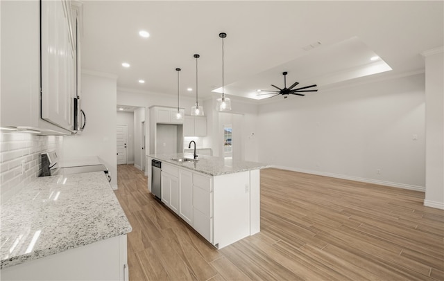 6202 Olivia St, Corpus Christi, TX 78415 - kitchen with stainless steel appliances, ornamental molding, a ceiling fan, backsplash, and white cabinets