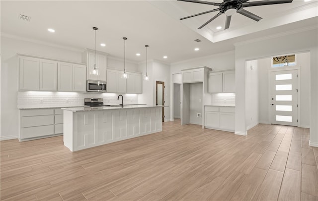 6202 Olivia St, Corpus Christi, TX 78415 - kitchen featuring stainless steel appliances, recessed lighting, a ceiling fan, decorative backsplash, and white cabinetry