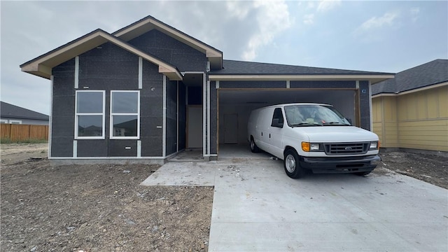 single story home with a garage, driveway, and fence