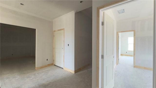 interior space featuring visible vents, concrete floors, baseboards, and crown molding