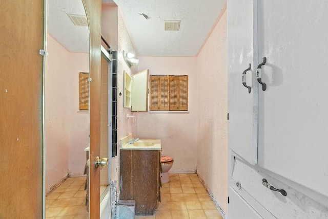 925 Hazel Dr, Corpus Christi, TX 78412 - full bathroom featuring vanity, tile patterned flooring, a textured ceiling, and a shower