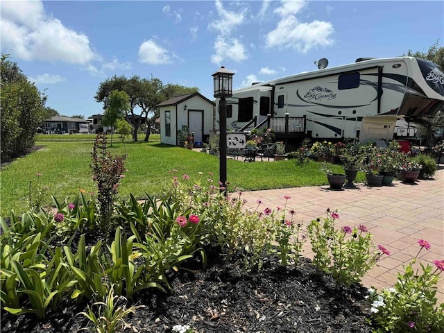 104 Augusta Cir, Aransas Pass, TX 78336 - view of home's community featuring a lawn, a patio, and an outbuilding