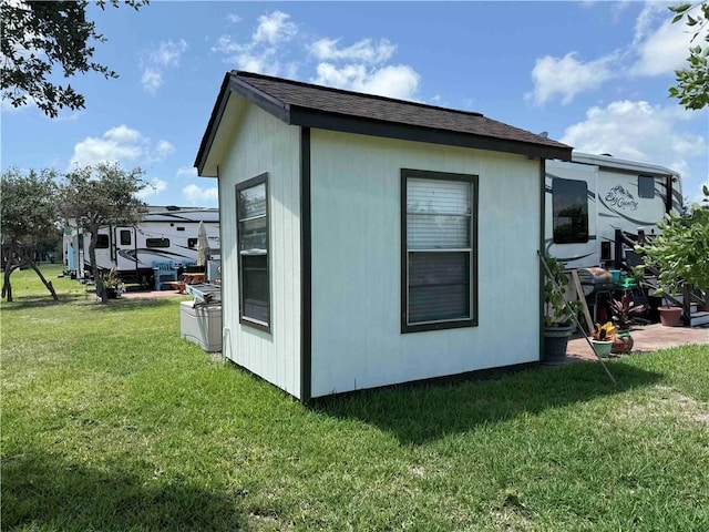 104 Augusta Cir, Aransas Pass, TX 78336 - view of side of property featuring a yard and roof with shingles