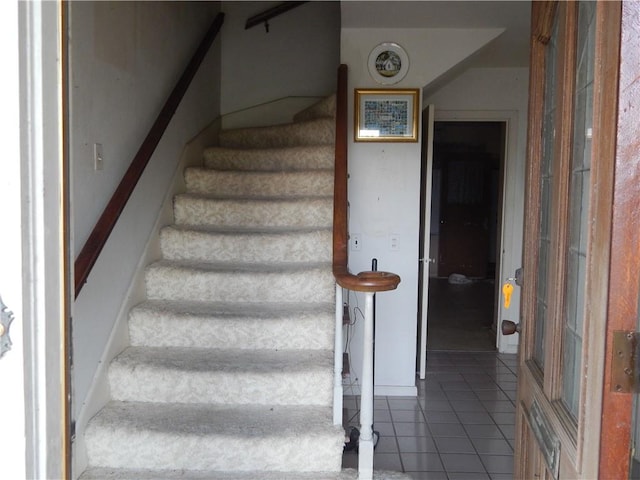 staircase featuring tile patterned flooring