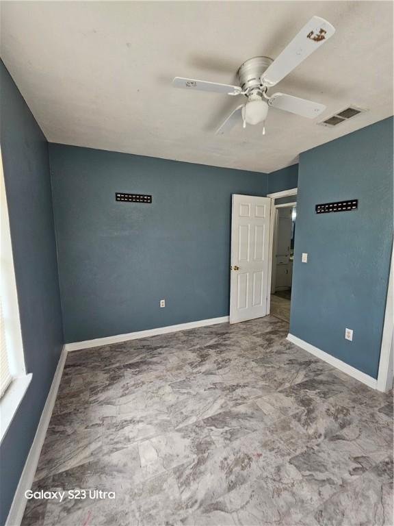 1330 Red Bird Dr, Rockport, TX 78382 - unfurnished bedroom featuring baseboards and a ceiling fan