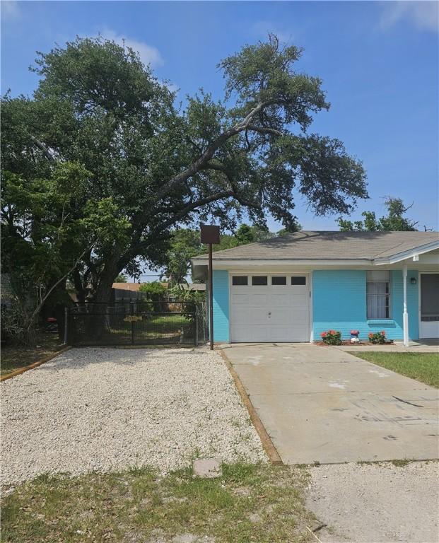 1330 Red Bird Dr, Rockport, TX 78382 - view of front facade featuring concrete driveway, a garage, and fence