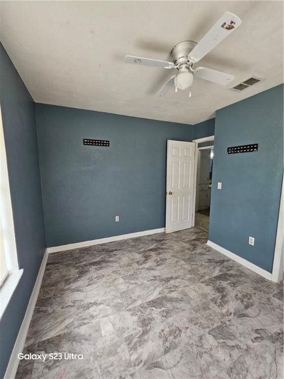 1330 Red Bird Dr, Rockport, TX 78382 - unfurnished bedroom featuring baseboards and a ceiling fan