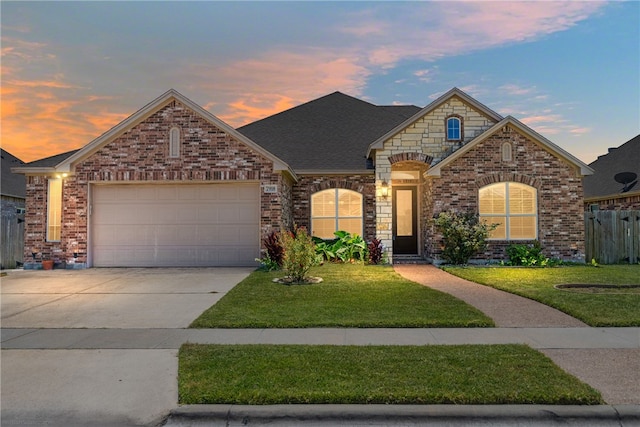 front facade with a garage and a yard