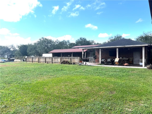 rear view of house with a patio and a yard