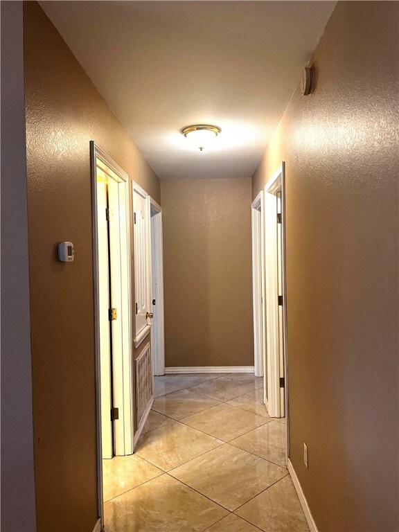 hallway featuring light tile patterned flooring