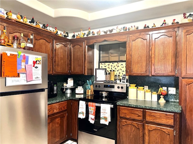 kitchen featuring stainless steel appliances and tasteful backsplash