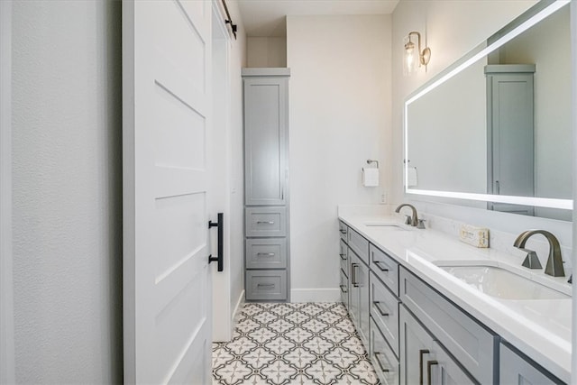 full bath with a sink, baseboards, and double vanity