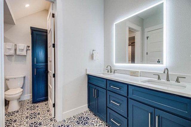 bathroom featuring tile patterned flooring, a sink, and baseboards